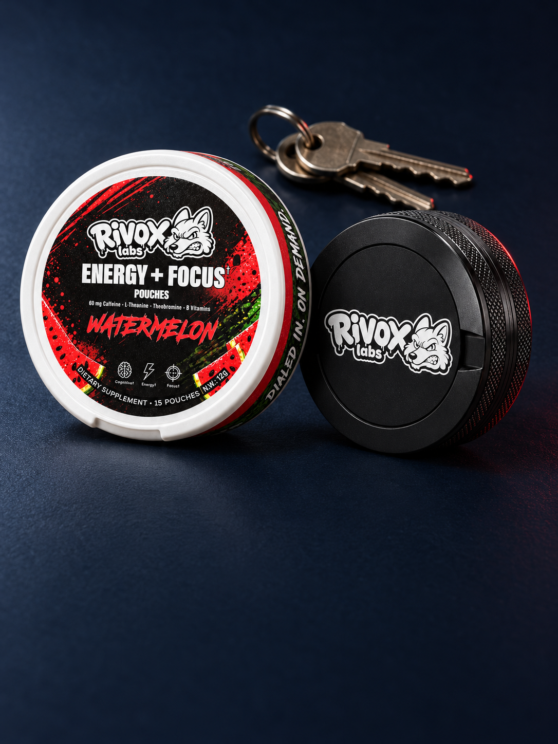 Rivox Watermelon focus pouch tin, black carry case and keys on a navy surface