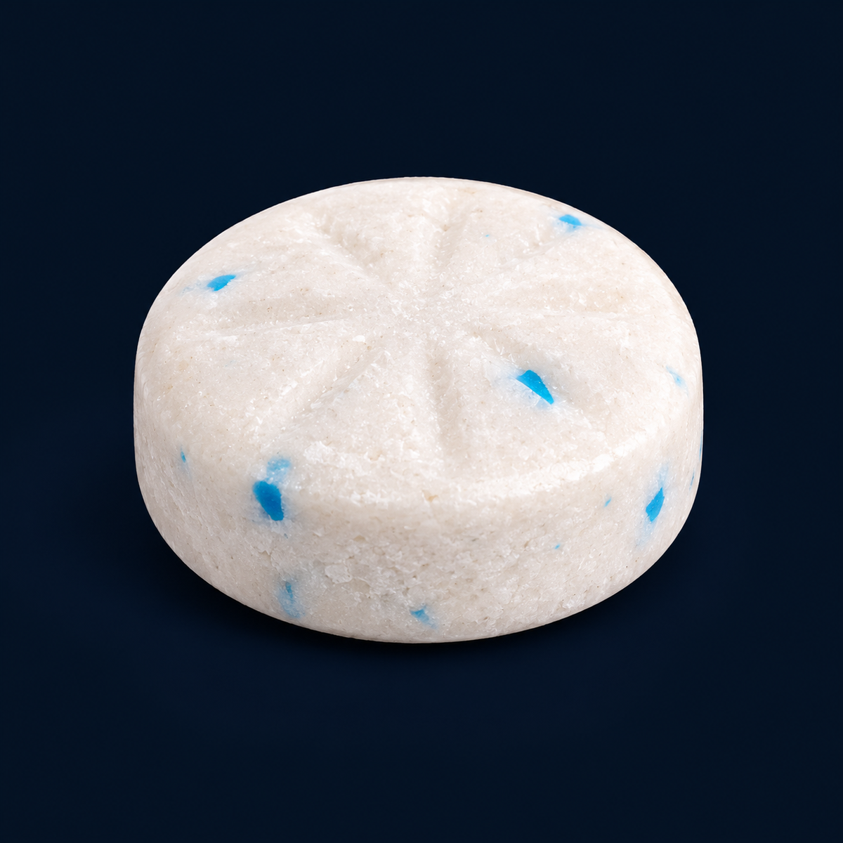 Close-up of a round off-white Rivox gum piece with blue flecks